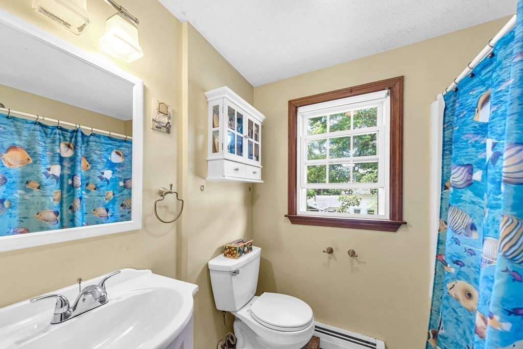 40 Prospect Street, Unit 1B Westfield, MA 01085 - Photo 12 of 24 a bathroom with a toilet sink and mirror