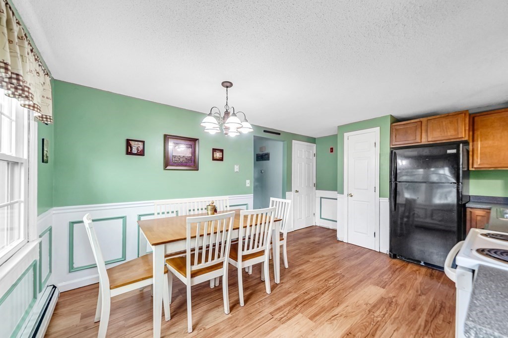 40 Prospect Street, Unit 1B Westfield, MA 01085 - Photo 5 of 24 a view of a dining room with furniture a chandelier and wooden floor