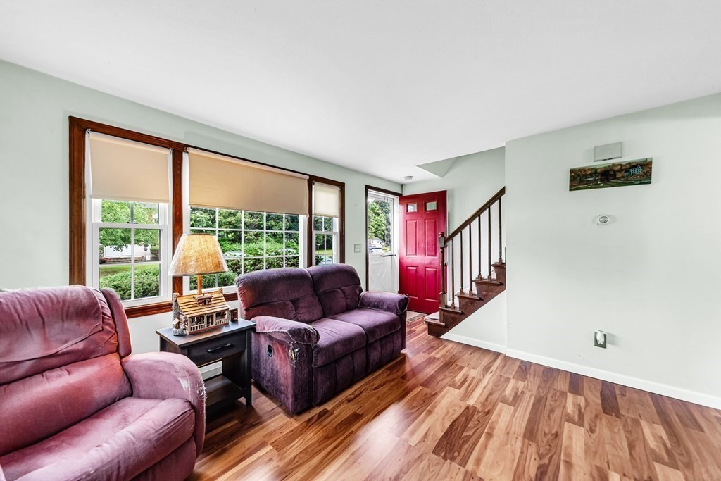 40 Prospect Street, Unit 1B Westfield, MA 01085 - Photo 8 of 24 a living room with furniture and a floor to ceiling window