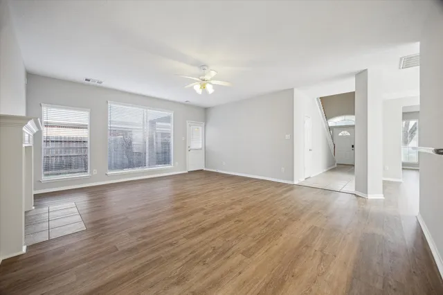 wooden floor fireplace and natural light in room