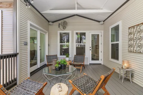 a view of a patio with table and chairs and potted plants