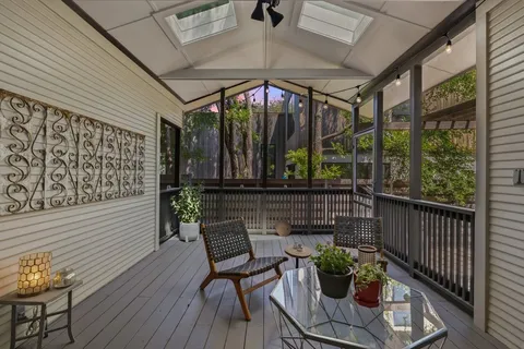 a view of a patio with table and chairs potted plants with wooden floor