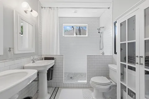 a bathroom with a sink toilet and shower