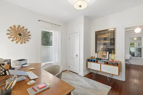 a living room with furniture and wooden floor
