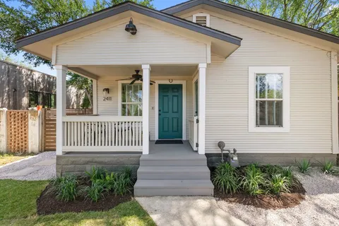 a front view of a house with a garden