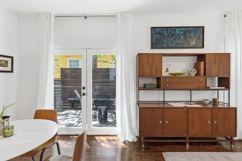 a view of a dining room with furniture and wooden floor