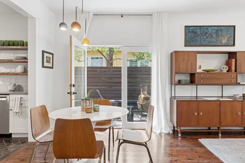 a dining room with furniture and window