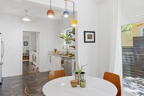 a dining room with table chairs and wooden floor