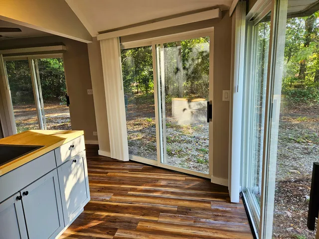 a view of a room with wooden floor and a window