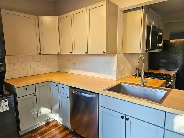 a kitchen with a sink and cabinets