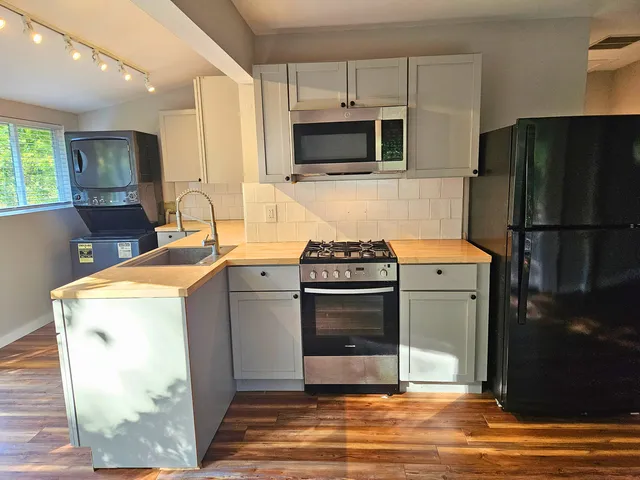 a kitchen with a refrigerator sink and stove