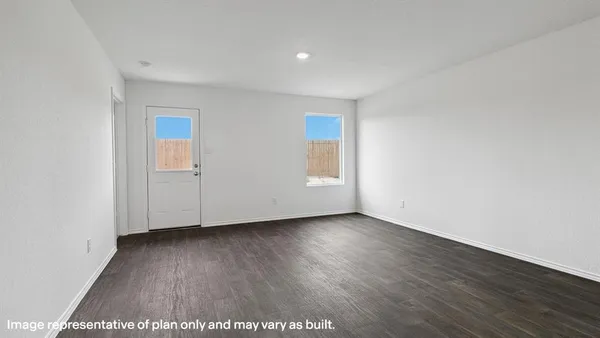 a view of an empty room with wooden floor and closet