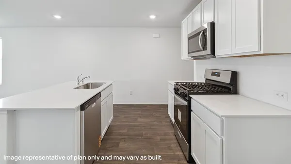 a kitchen that has a sink and a stove top oven