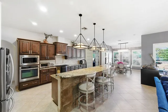 a large kitchen with a table and chairs