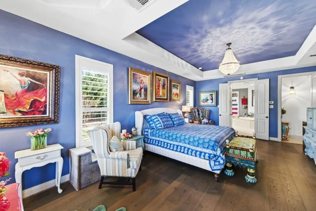 a spacious bedroom with two beds and a chandelier