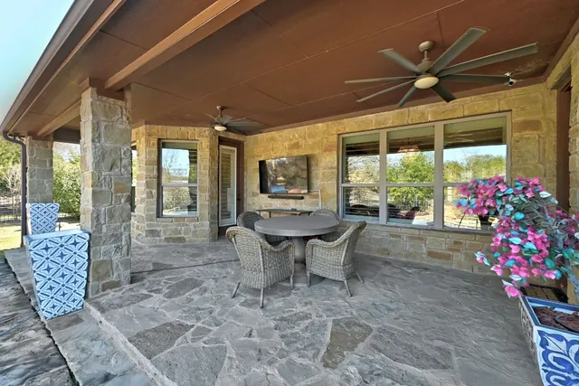 a bathroom with a granite countertop sink a toilet a mirror and shower