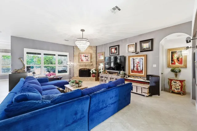 a living room with furniture fireplace and a window