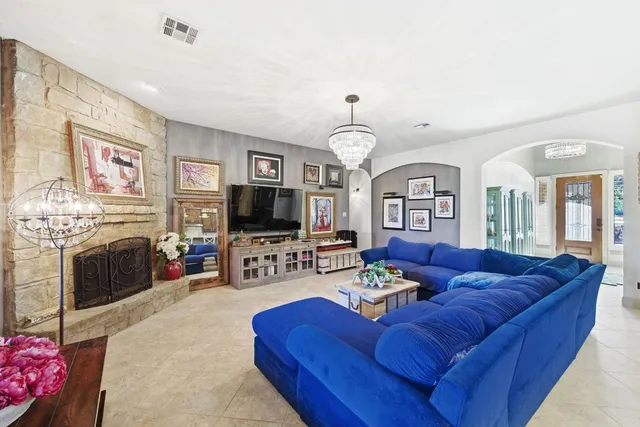 a living room with furniture a fireplace and a flat screen tv