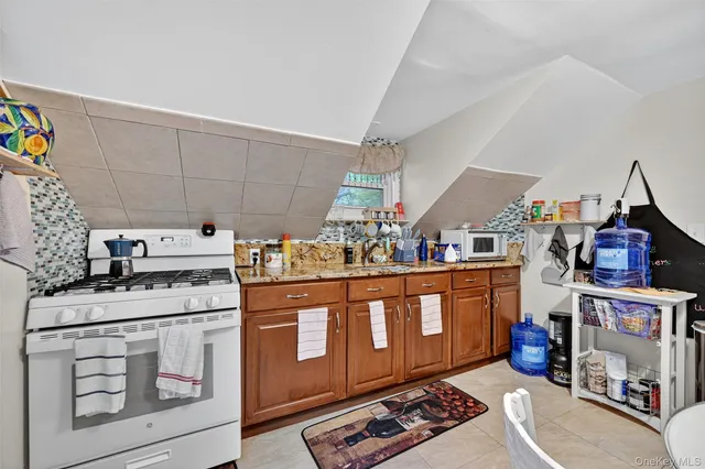 a living room with furniture and a dining table