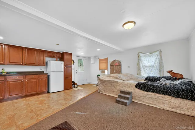 a kitchen with a refrigerator sink and cabinets