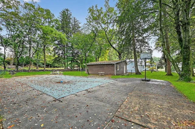 a view of a backyard with large trees