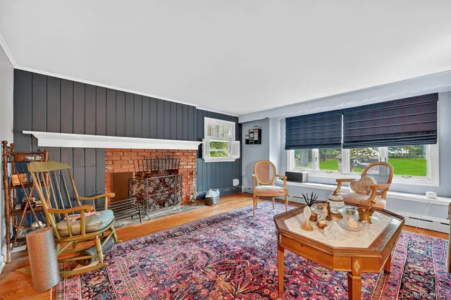 a living room with furniture a window and a table