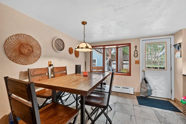 a dining room with a wooden table and chairs