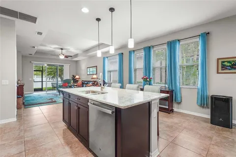 a living room with furniture and a view of kitchen