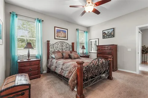 a bedroom with a bed and dresser with mirror