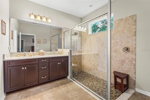 a spacious bathroom with a double vanity sink and a mirror