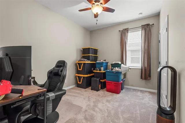 a living room with furniture and a gym machine