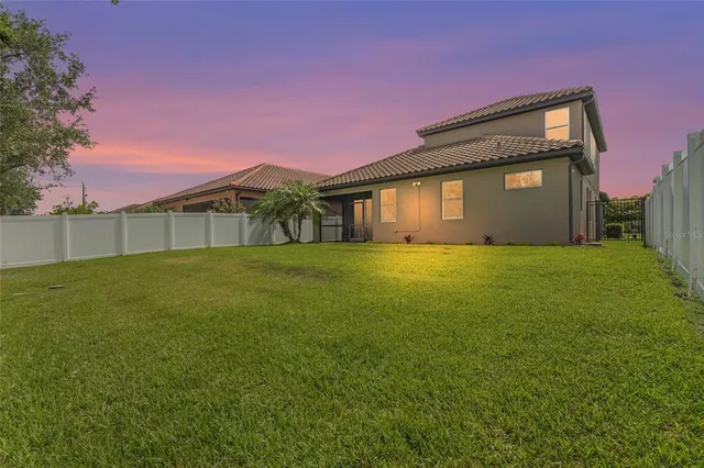 a front view of a house with a yard and potted plants