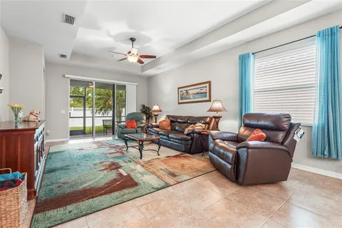a living room with furniture and a view of kitchen