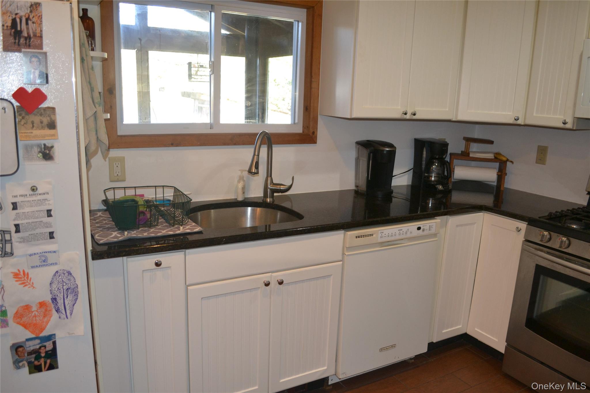 238 Trout Brook Road Roscoe, NY 12776 - Photo 12 of 32 a kitchen with granite countertop white cabinets and white appliances