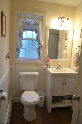 a bathroom with a sink toilet and mirror