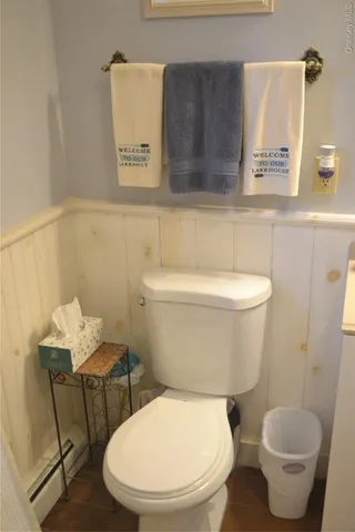 a white toilet sitting next to a bathroom sink