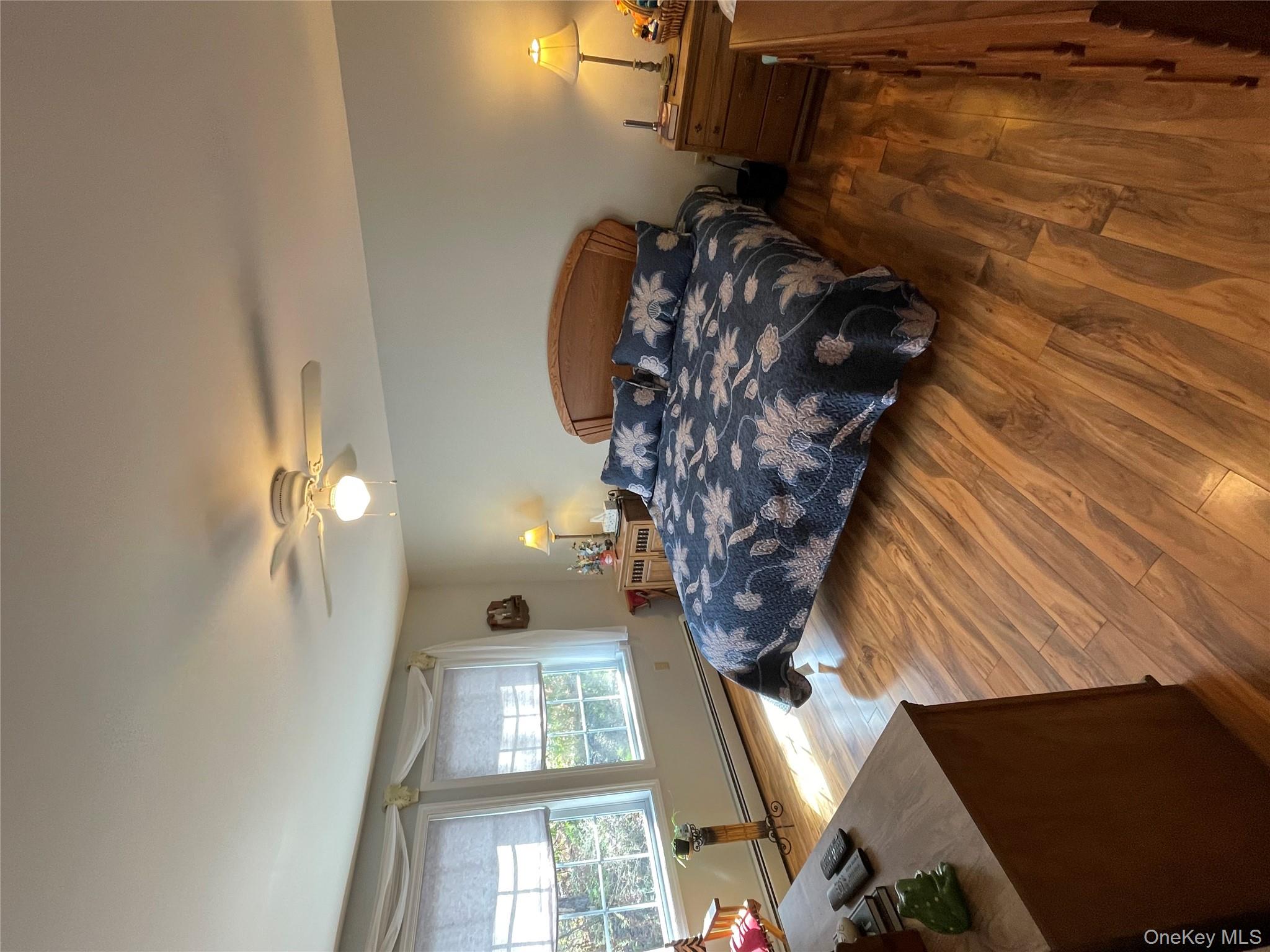 238 Trout Brook Road Roscoe, NY 12776 - Photo 19 of 32 a bedroom with a bed lamps and wooden floor