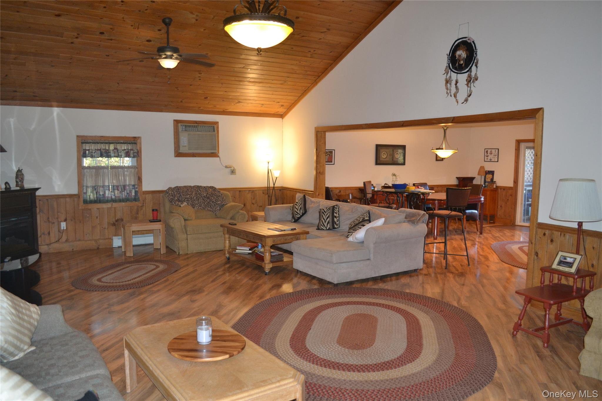 238 Trout Brook Road Roscoe, NY 12776 - Photo 7 of 32 a living room with furniture a rug and a chandelier