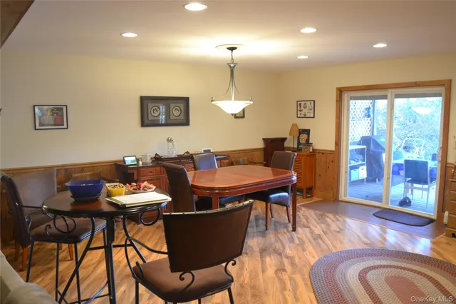 a dining room with furniture a window and wooden floor