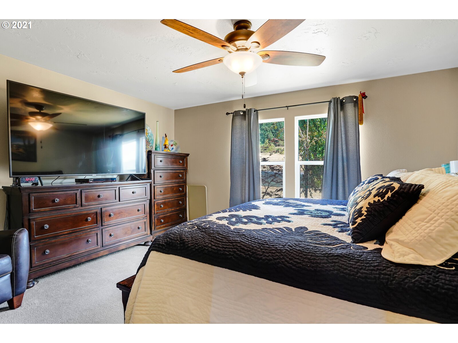 32300 Hidden Valley Road Lebanon, OR 97355 - Photo 15 of 29 a bedroom with a bed and a flat screen tv