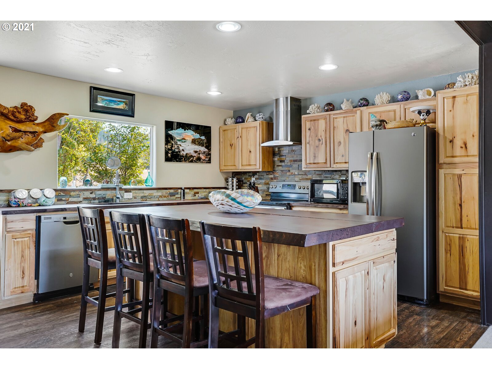32300 Hidden Valley Road Lebanon, OR 97355 - Photo 3 of 29 a kitchen with stainless steel appliances granite countertop a table chairs and a refrigerator