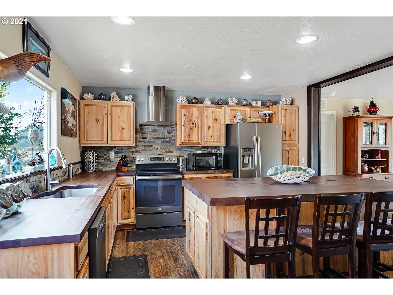32300 Hidden Valley Road Lebanon, OR 97355 - Photo 4 of 29 a kitchen with stainless steel appliances granite countertop a kitchen island a stove and a sink