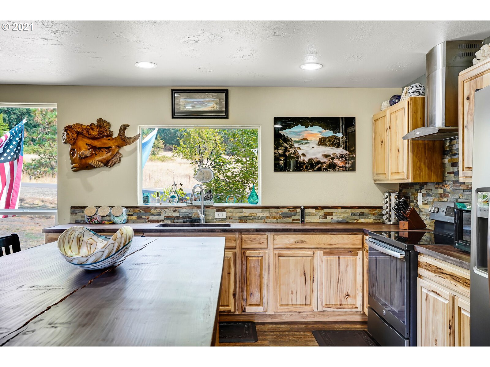 32300 Hidden Valley Road Lebanon, OR 97355 - Photo 5 of 29 a kitchen with stainless steel appliances a stove a sink and a refrigerator