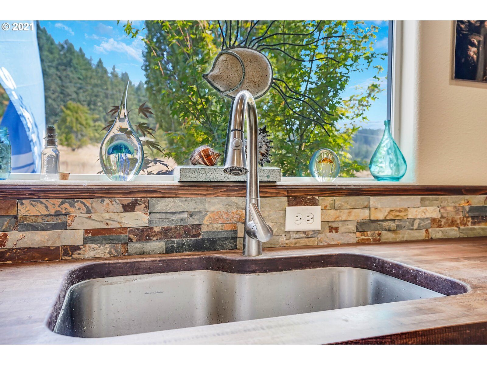 32300 Hidden Valley Road Lebanon, OR 97355 - Photo 6 of 29 a view of a kitchen counter top a stove and a window