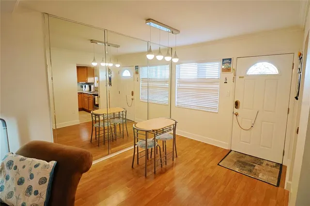 a living room with a dining table and a chandelier