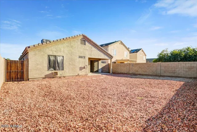 a view of a house with a backyard