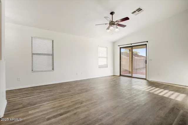 wooden floor in an empty room with a window