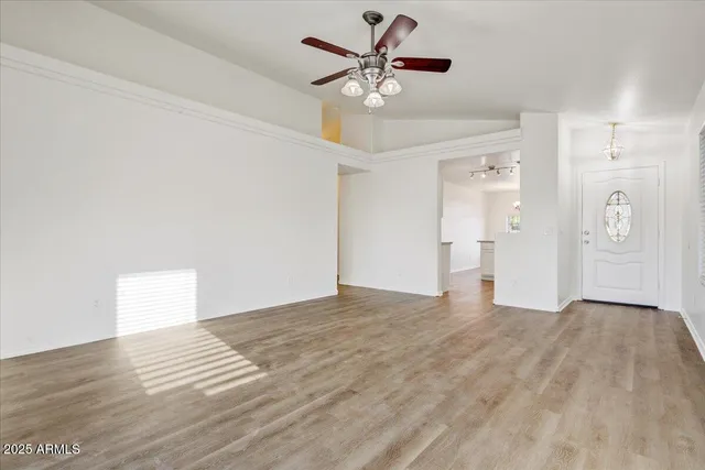 a view of an empty room with a ceiling fan