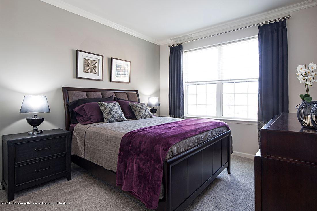 249 Broad Street, Unit 401 Matawan, NJ 07747 - Photo 14 of 27 a bedroom with a bed and a window