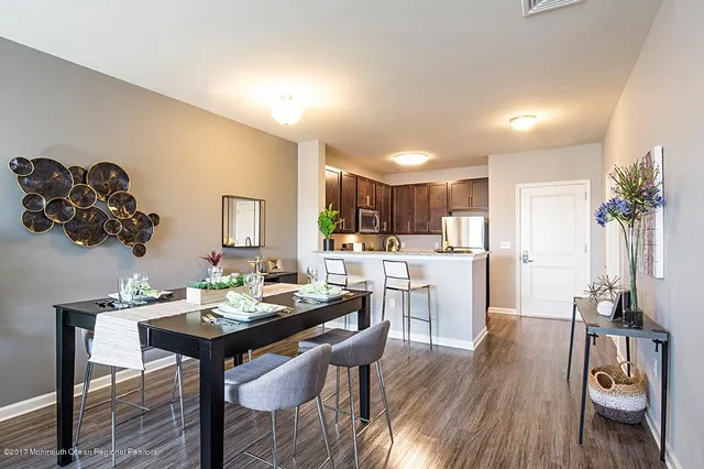 a living room with kitchen island furniture and a wooden floor